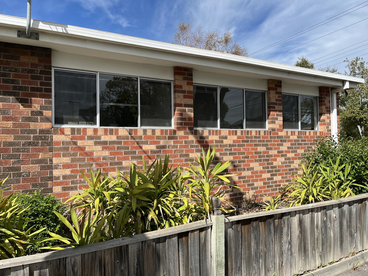 Side exterior windows of GP practice — after clean